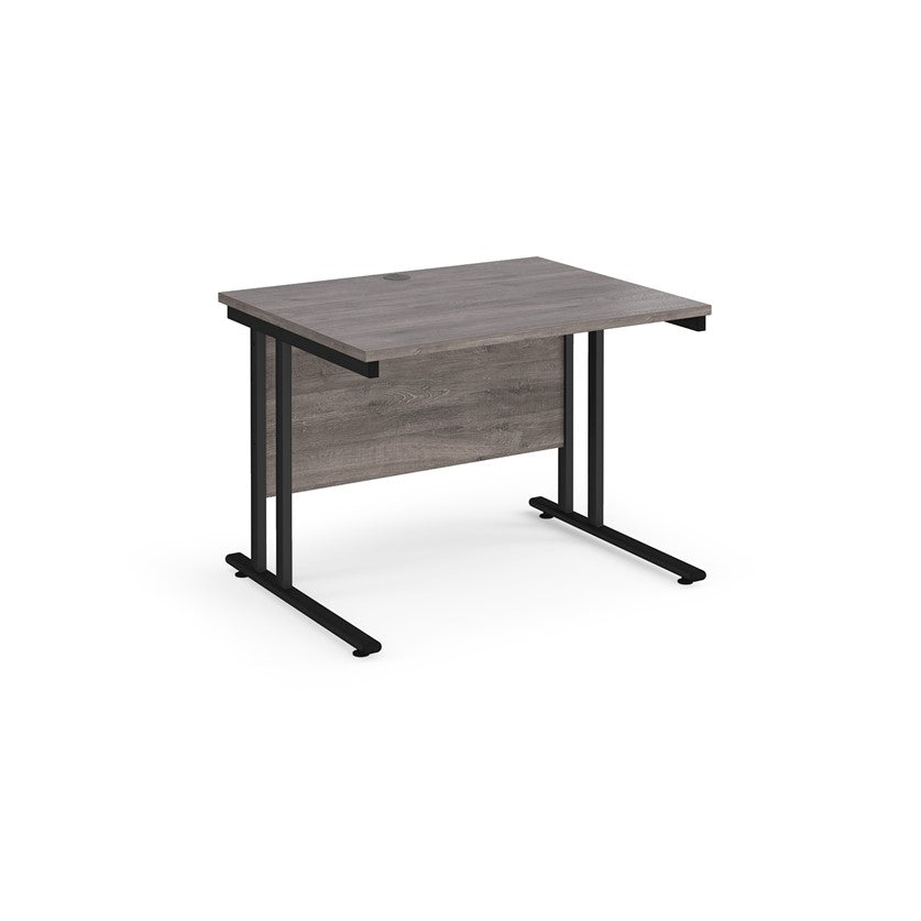 A grey desk with a black cantilever frame. 