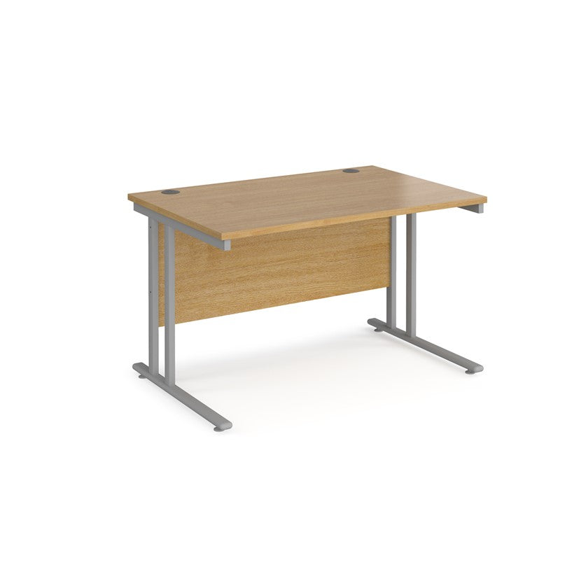 An oak desk with a grey cantilever frame.