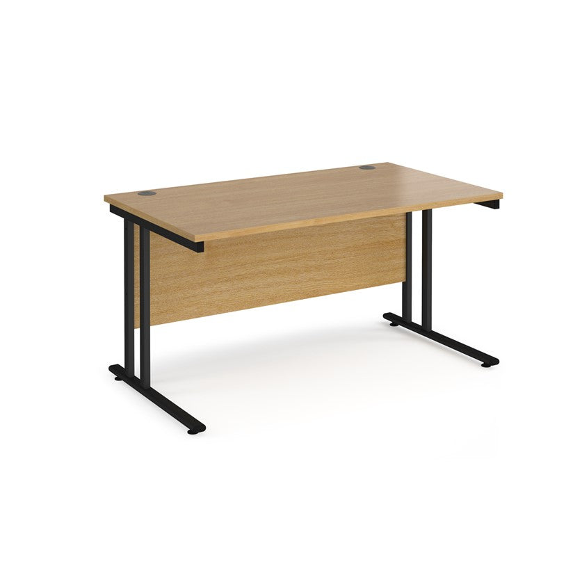 An oak desk with a black cnatilever frame.