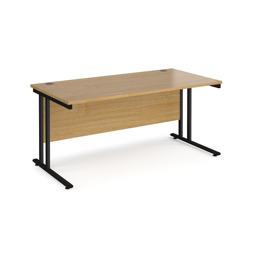 An oak desk with a black cantilever frame. 