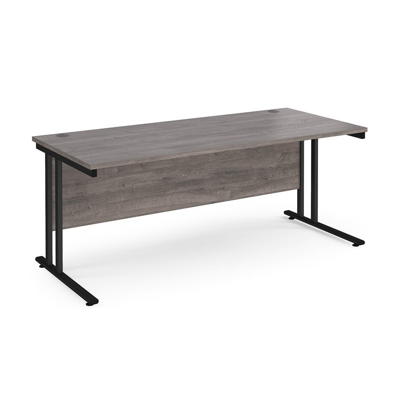 A grey desk with a black cantilever frame. 