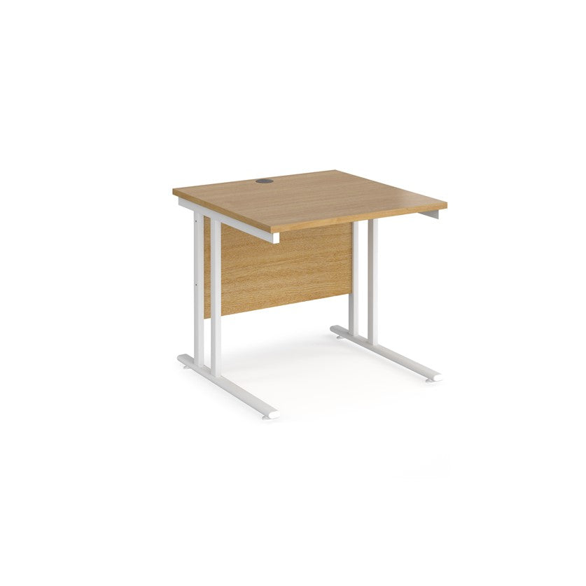 A rectangular office desk with a cantilever frame and melamine desktop, with one cable access port visible.