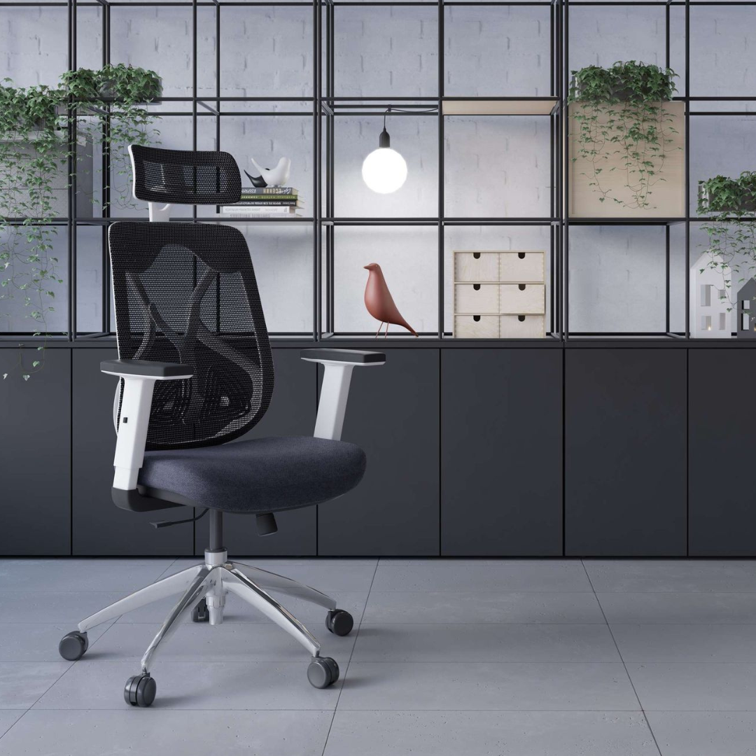 Black office chair in a modern office setting with glass walls and shelves.
