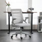 White office chair in front of a desk with a blurred background