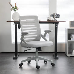 White office chair in front of a desk with a blurred background