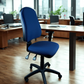 Blue office chair in a modern office setting with wooden desks and large windows.