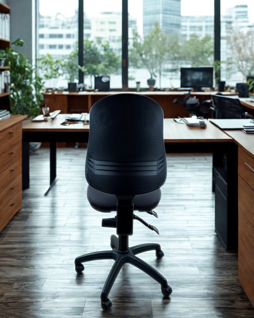 almost black office chair in a modern office setting with large windows.