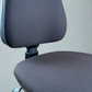 Almost black office chair with adjustable features on a plain background