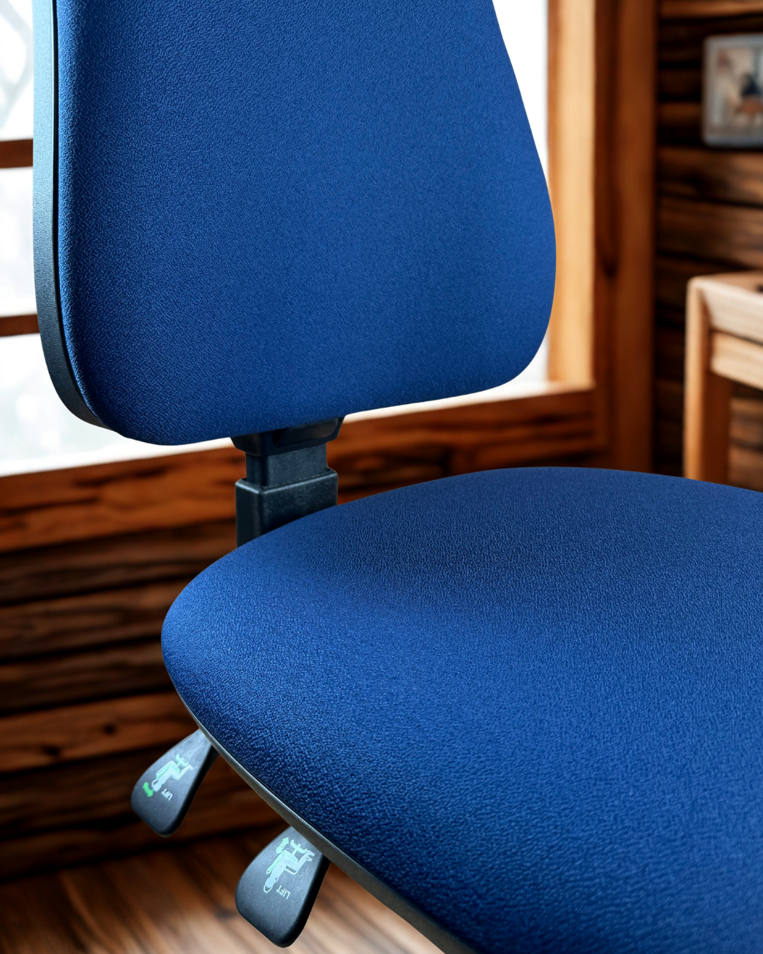Blue office chair in an indoor setting with wooden walls.
