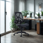 Modern office chair in a well-lit room with a desk and plants.