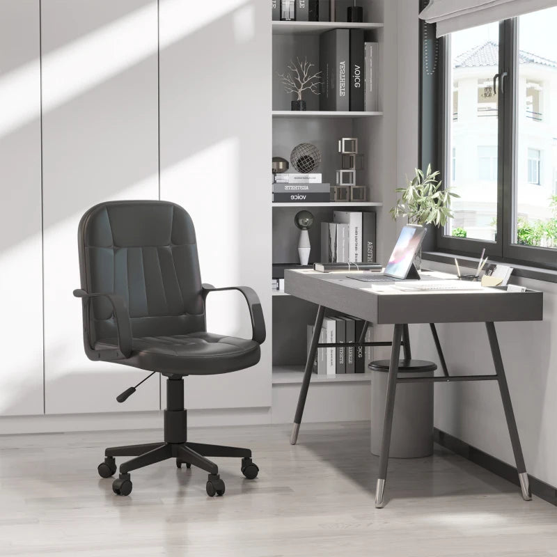 Modern office setup with a black office chair and desk in a bright room.