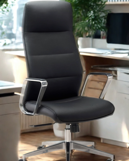 Black office chair in a modern office setting with a desk and computer monitor.
