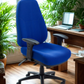 Blue office chair in a room with a desk and plants