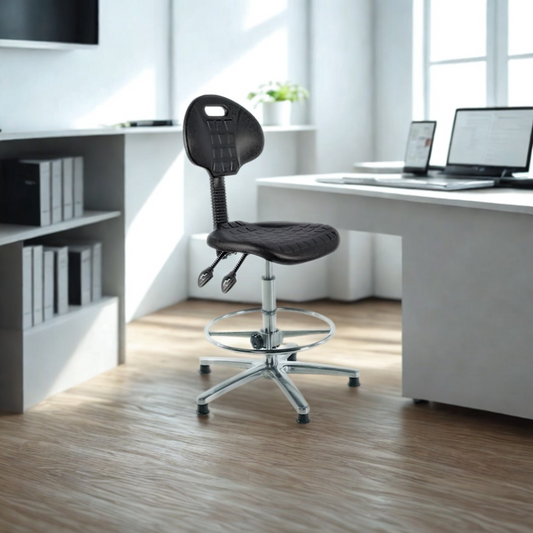 Black office chair in a modern office setting with a desk and computer.