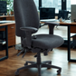 Charcoal office chair in an office setting with desks and computers.
