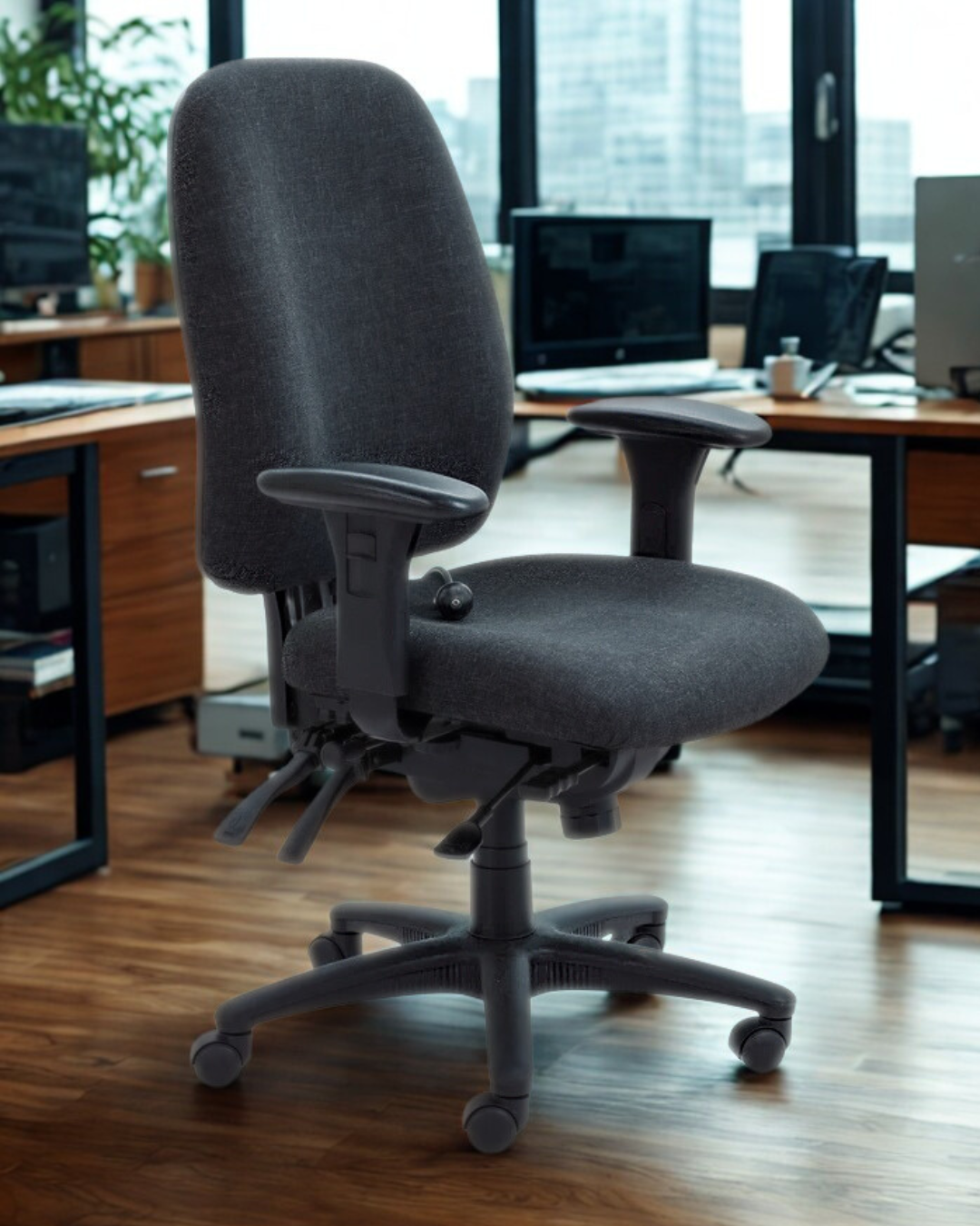 Charcoal office chair in an office setting with desks and computers.