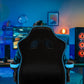 Person sitting in a gaming chair in a room with blue lighting, facing a computer setup.