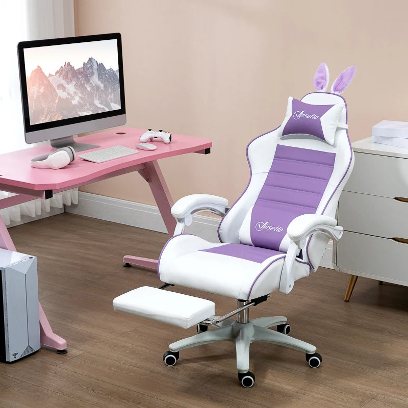 Ergonomic purple chair with bunny ears in a room with a pink desk and computer setup.