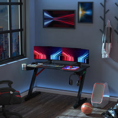 Racing Style Gaming Desk with LED Lights and Cup Holder, Black in a bedroom setting
