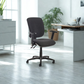 Dark gray office chair in a modern office setting with desks and plants.