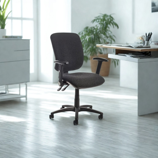 Dark gray office chair in a modern office setting with desks and plants.