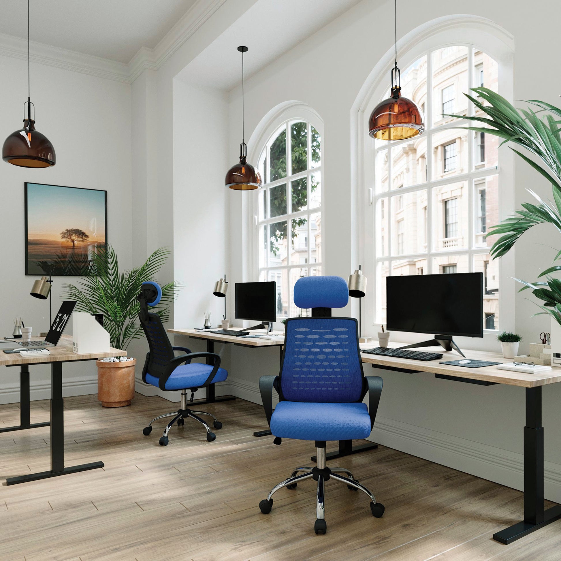 Modern office setup with a blue chair, desk, and computer monitors.