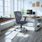 Modern office setup with a desk, chair, and computer in a bright room.