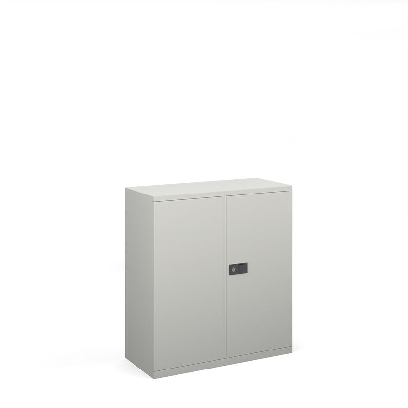 A white steel cupboard with fully lockable double doors and a three-point locking system. It has a flat top and the unit is depicted against a white background.