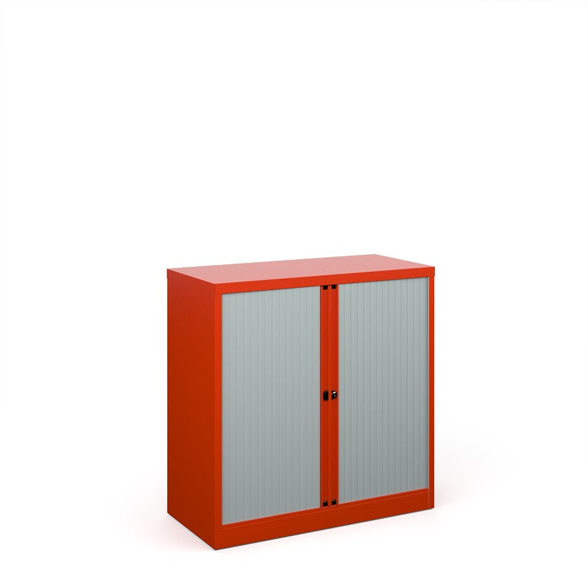 A red orange storage cabinet with tambour doors, fully assembled, with no visible shelves inside.
