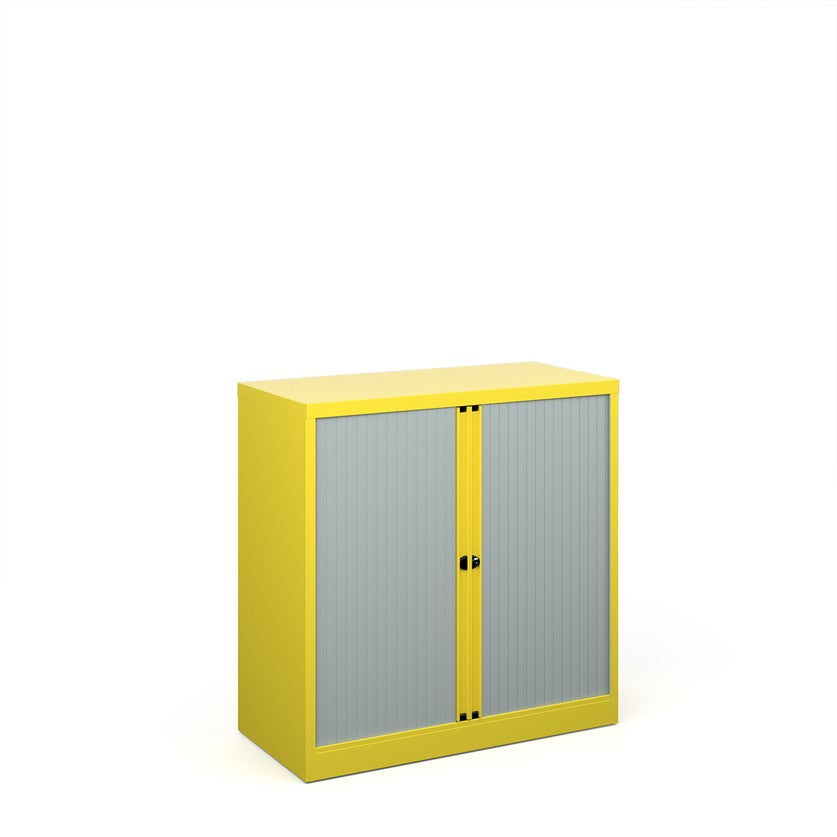A yellow cabinet with grey doors on a white background. 