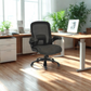 Gray office chair in a bright office with a desk and plants.