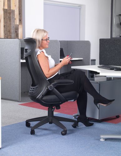 Woman sitting on a black office chair in an office setting.