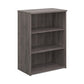 A wooden bookcase with a single opening tambour door and two shelves, made with grey finish.