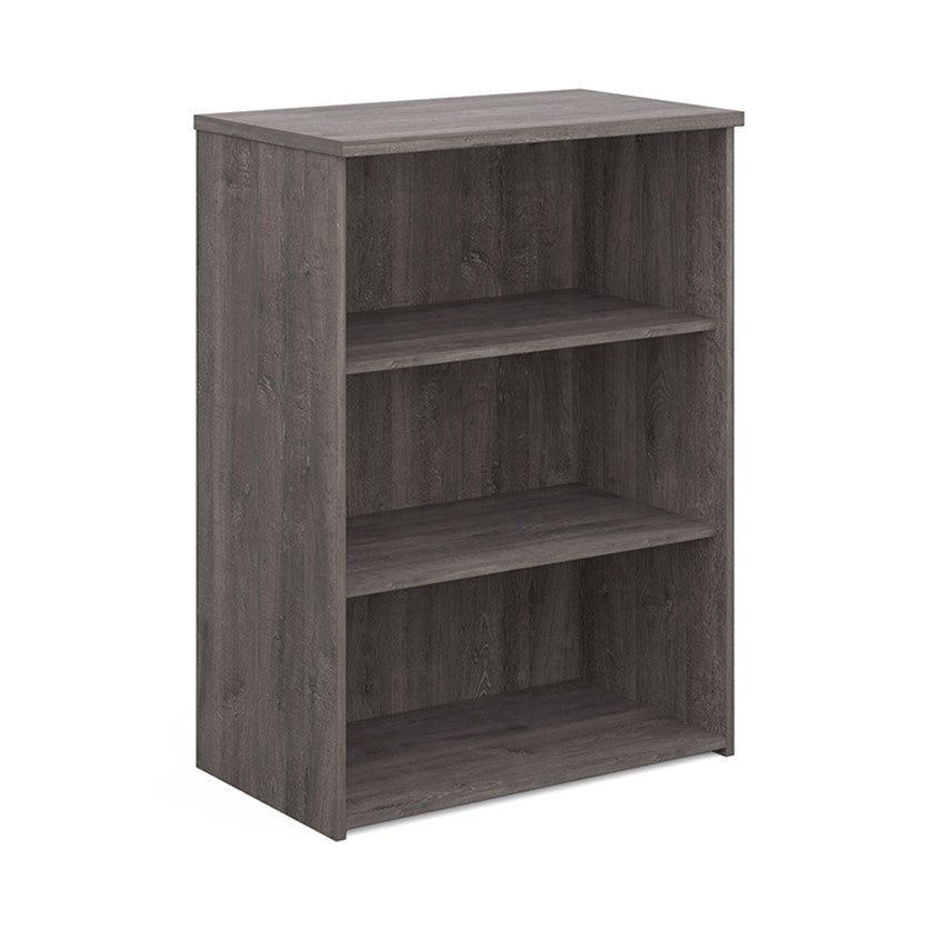 A wooden bookcase with a single opening tambour door and two shelves, made with grey finish.