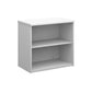 A wooden bookcase with a single opening tambour door and two shelves, made with white finish.