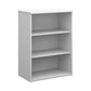 A wooden bookcase with a single opening tambour door and two shelves, made with a white finish.