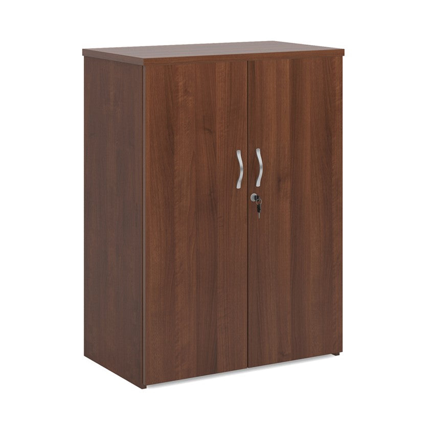 A wooden cupboard with walnut finish, featuring a pair of lockable doors with silver handles and a solid back panel.